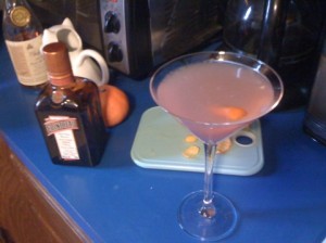 A cocktail glass containing a Cosmopolitan or Cosmo made with Cointreau