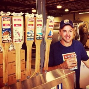 Rick Sobotka of Great South Bay Brewing stands by five taps of his beer.