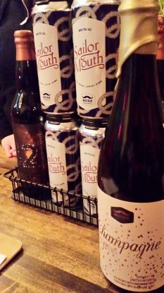 A bottle of 42, cans of Sailor Mouth, and a bottle of Champagne Showers at Moustache Brewing Co in Riverhead, NY