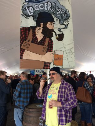 Fervere stands by the sign welcoming people to the 2016 Blue Point Logger Lager