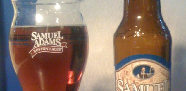 Samuel Adams Revolutionary Rye Ale poured into a glass, next to the bottle.