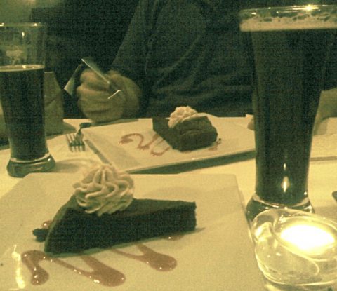Two glasses of Black Duck Porter and two flour-less chocolate cakes