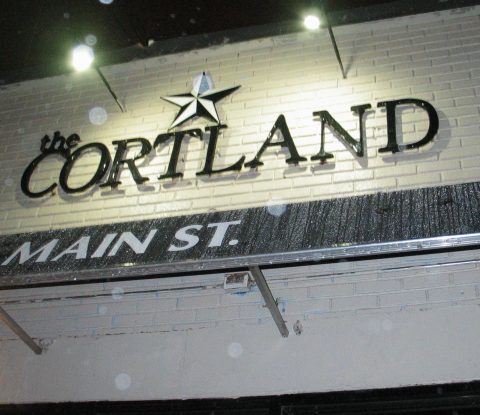 The Cortland facade on a rainy night