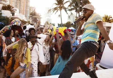 A diverse group of young people dancing on an outdoor pavilion in Barbados