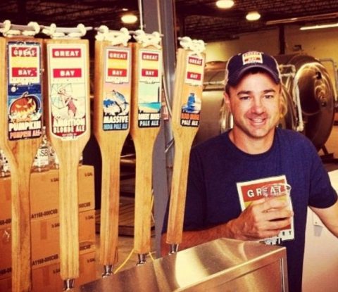 Rick Sobotka of Great South Bay Brewing stands by five taps of his beer.