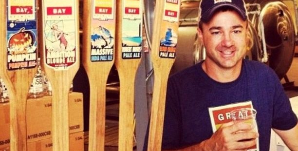 Rick Sobotka of Great South Bay Brewing stands by five taps of his beer.