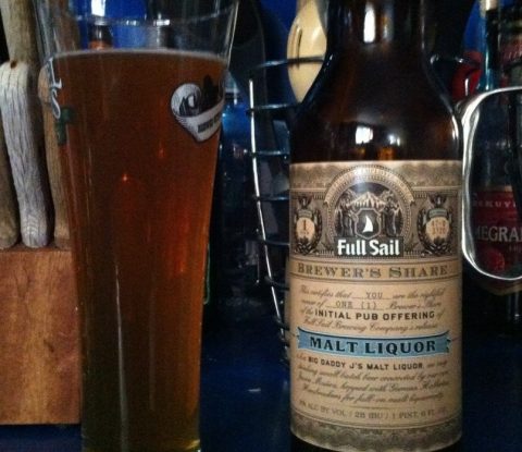 A pint of Full Sail Big Daddy J’s Malt Liquor next to a bottle of the same.