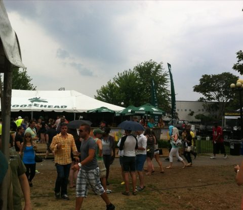 Several people walk by the Moosehead tent on an overcast day at Toronto’s Festival of Beer 2013.