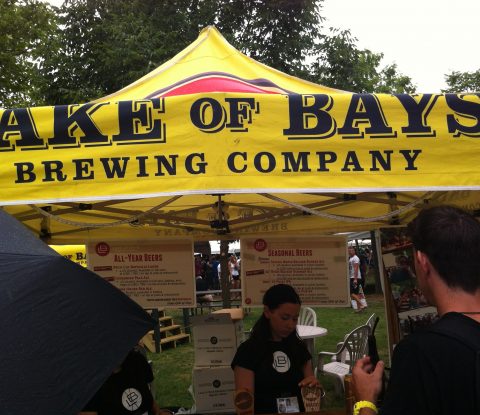 Servers pour beer under the Lake of Bays Brewing Company tent at Toronto’s Festival of Beer.