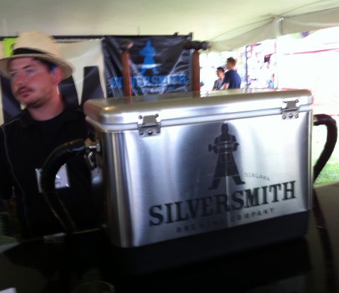 A gentleman in a straw hat waits to serve Silversmith Black Lager to people at Toronto’s Festival of Beer