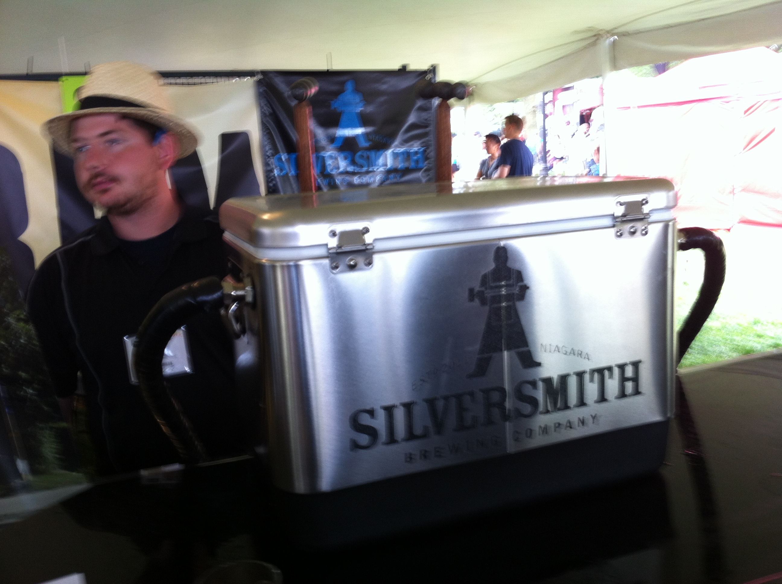 A gentleman in a straw hat waits to serve Silversmith Black Lager to people at Toronto’s Festival of Beer
