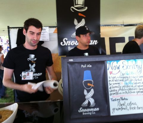Two gentlemen in black Snowman Brewing Co. t-shirts wait to pour Pail Ale at Toronto’s Festival of Beer
