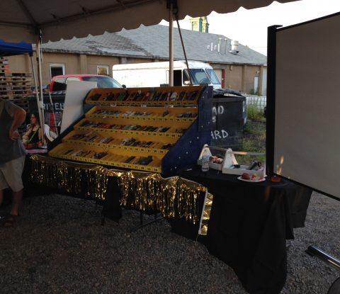 A large, yellow pinewood-car case holds up to 100 cars, waiting to race at Long Ireland Brewing’s Pintwood Derby