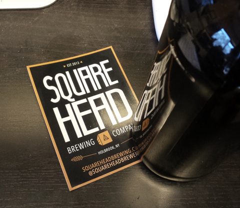 A Square Head Brewery sticker with a brown bottle covering the lower right corner