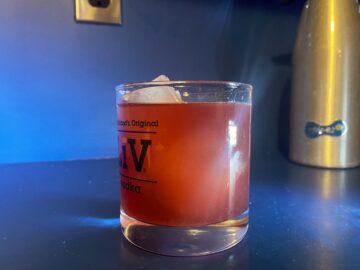 A cranberry margarita in a low ball glass