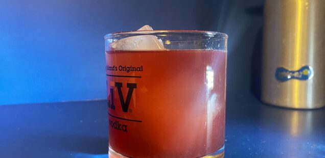 A cranberry margarita in a low ball glass
